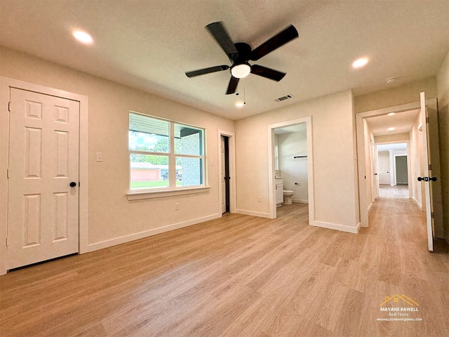 2630 34th St, Port Arthur, TX 77640 - unfurnished bedroom with light wood-type flooring, recessed lighting, ensuite bath, and a textured ceiling