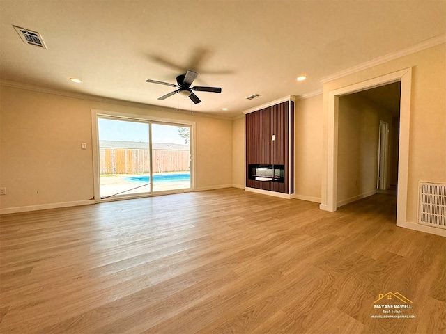 2630 34th St, Port Arthur, TX 77640 - unfurnished living room with ornamental molding, ceiling fan, light wood finished floors, and recessed lighting
