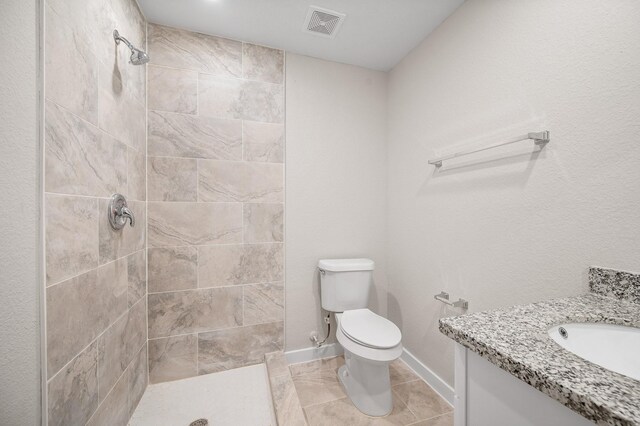 6315 Sandra St, Houston, TX 77028 - bathroom featuring tiled shower, vanity, and tile patterned floors