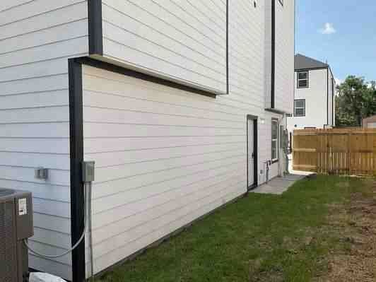 6313 Sandra St, Houston, TX 77028 - view of side of home with a central AC unit