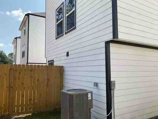 6313 Sandra St, Houston, TX 77028 - view of side of home featuring a central air condition unit