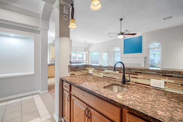 7422 Quiet Glen Dr, Sugar Land, TX 77479 - kitchen featuring tasteful backsplash, ceiling fan, dark stone countertops, plenty of natural light, and ornamental molding