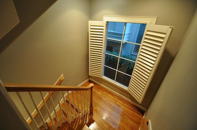 109 Dennis St, Houston, TX 77006 - stairway featuring wood finished floors and baseboards
