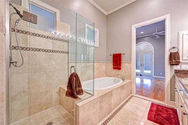 109 Dennis St, Houston, TX 77006 - full bath featuring tile patterned flooring, a stall shower, crown molding, a bath, and vanity