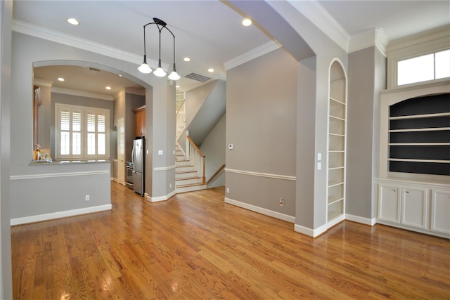 109 Dennis St, Houston, TX 77006 - unfurnished living room with healthy amount of natural light, ornamental molding, light wood-style floors, built in features, and recessed lighting