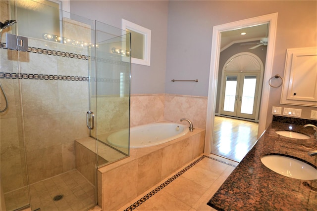 109 Dennis St, Houston, TX 77006 - full bath featuring tile patterned floors, french doors, a stall shower, a garden tub, and double vanity