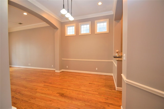 109 Dennis St, Houston, TX 77006 - unfurnished room featuring ornamental molding, arched walkways, light wood-style flooring, and recessed lighting