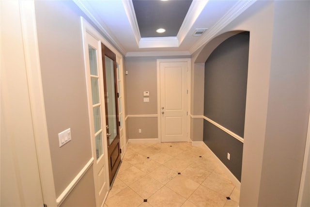 109 Dennis St, Houston, TX 77006 - hall featuring crown molding, arched walkways, a tray ceiling, light tile patterned floors, and recessed lighting