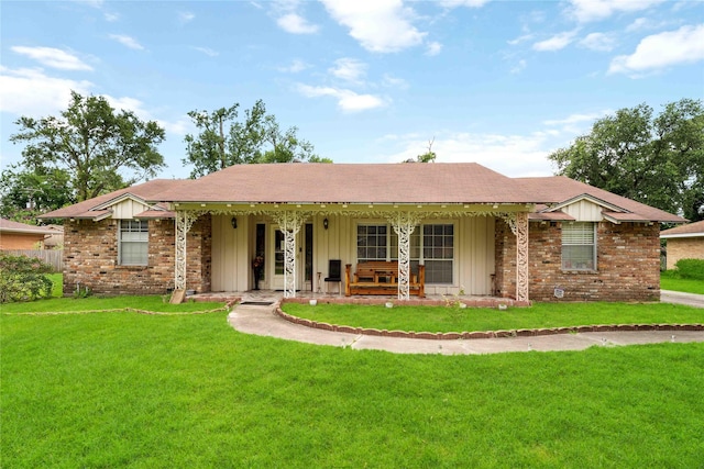 408 Rolling Wood Rd, Baytown, TX 77520 - ranch-style home with a porch, board and batten siding, and a front yard