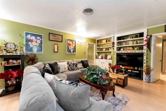 408 Rolling Wood Rd, Baytown, TX 77520 - living area featuring light wood-style flooring and a textured ceiling