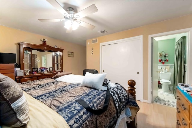 408 Rolling Wood Rd, Baytown, TX 77520 - bedroom with wood finished floors, a closet, a ceiling fan, and ensuite bath