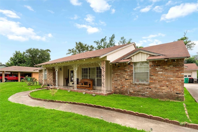408 Rolling Wood Rd, Baytown, TX 77520 - ranch-style house with a front lawn, covered porch, a garage, and brick siding