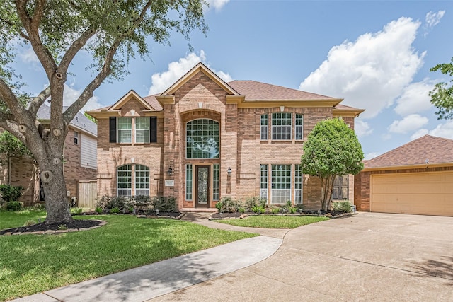 9526 Fern Wood Frst, Houston, TX 77040 - traditional-style home featuring concrete driveway, brick siding, a front yard, and a garage