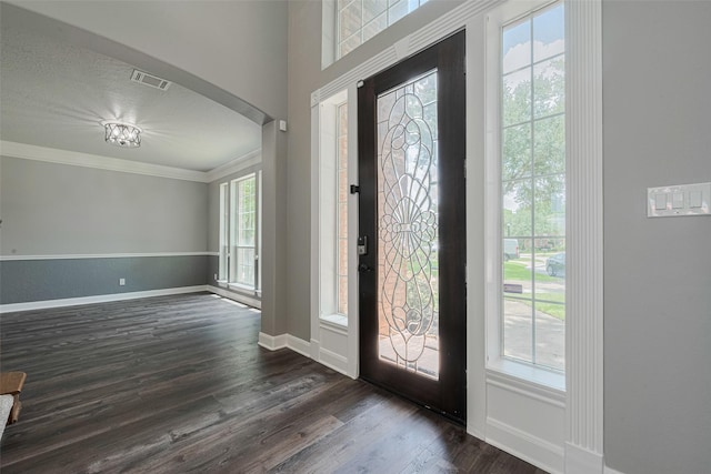 9526 Fern Wood Frst, Houston, TX 77040 - entryway with crown molding, dark wood-type flooring, and arched walkways