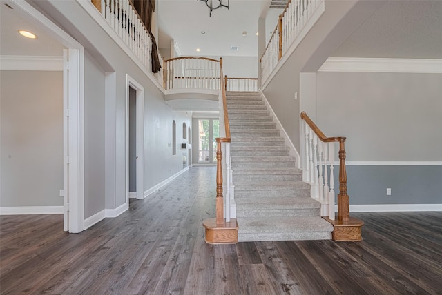 9526 Fern Wood Frst, Houston, TX 77040 - stairs with wood finished floors, a towering ceiling, crown molding, recessed lighting, and arched walkways