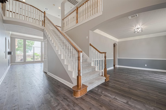 9526 Fern Wood Frst, Houston, TX 77040 - stairs featuring arched walkways, ornamental molding, wood finished floors, and a high ceiling