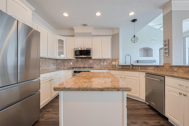 9526 Fern Wood Frst, Houston, TX 77040 - kitchen with stainless steel appliances, dark wood finished floors, light stone counters, recessed lighting, and tasteful backsplash