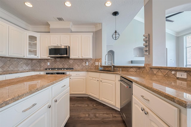 9526 Fern Wood Frst, Houston, TX 77040 - kitchen featuring stainless steel appliances, crown molding, dark wood-style floors, light stone counters, and pendant lighting