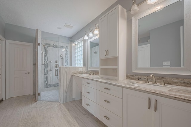 9526 Fern Wood Frst, Houston, TX 77040 - bathroom featuring double vanity, a shower stall, and wood finished floors