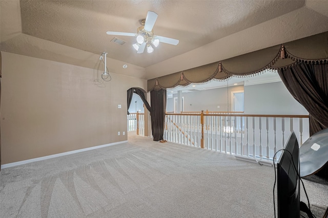 9526 Fern Wood Frst, Houston, TX 77040 - carpeted empty room with a ceiling fan, a textured ceiling, and arched walkways