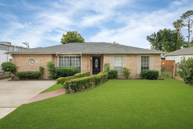 740 Post St, Houston, TX 77022 - ranch-style home featuring brick siding, roof with shingles, and driveway