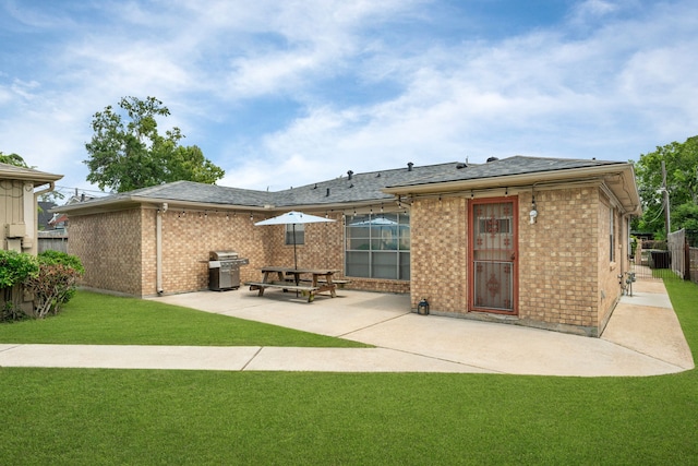 740 Post St, Houston, TX 77022 - rear view of house with a patio, brick siding, and roof with shingles