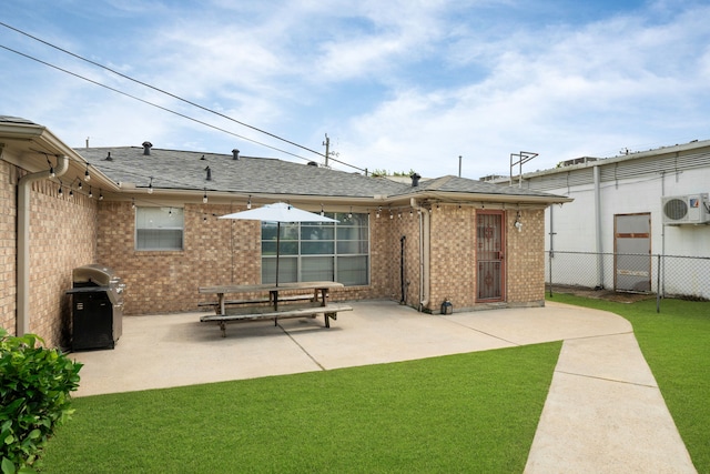 740 Post St, Houston, TX 77022 - rear view of property featuring a patio area, brick siding, and a shingled roof