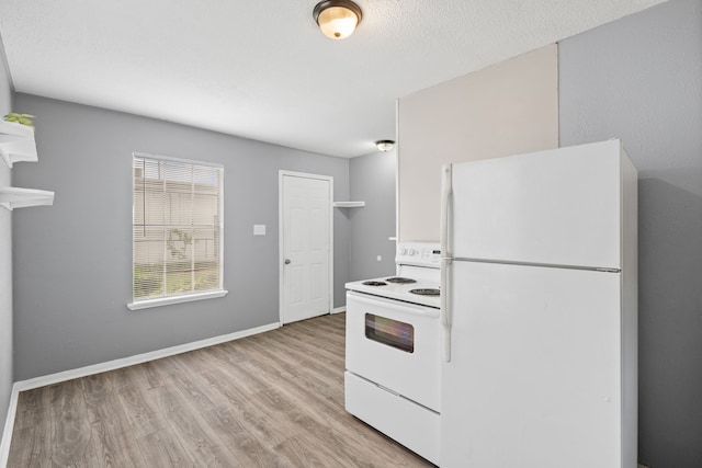 740 Post St, Houston, TX 77022 - kitchen featuring white appliances and light wood-type flooring