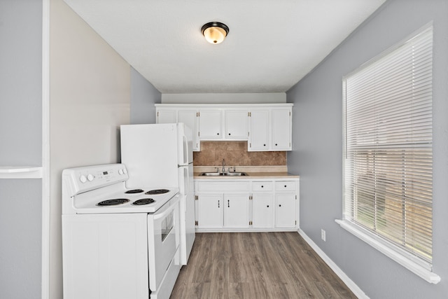 740 Post St, Houston, TX 77022 - kitchen with electric stove, wood finished floors, white cabinetry, and backsplash
