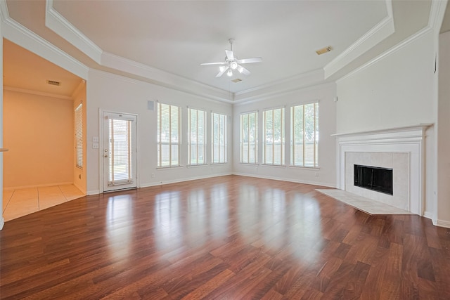 7927 Chateau Point Ln, Houston, TX 77041 - unfurnished living room with a ceiling fan, plenty of natural light, ornamental molding, wood finished floors, and a tile fireplace
