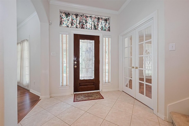 7927 Chateau Point Ln, Houston, TX 77041 - foyer entrance featuring crown molding, healthy amount of natural light, light tile patterned floors, arched walkways, and french doors