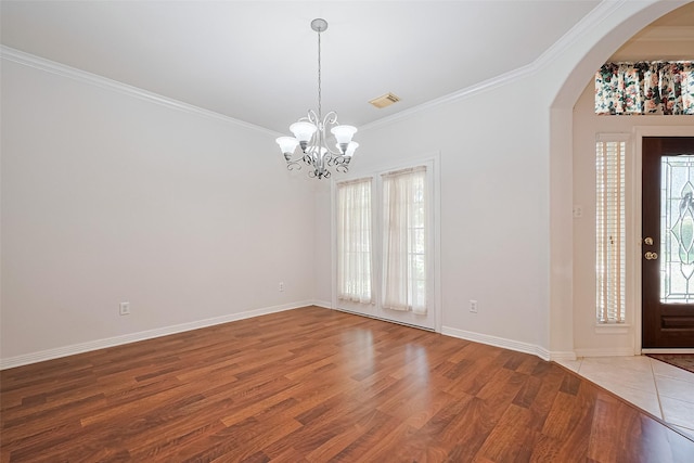 7927 Chateau Point Ln, Houston, TX 77041 - foyer featuring arched walkways, a chandelier, wood finished floors, and crown molding