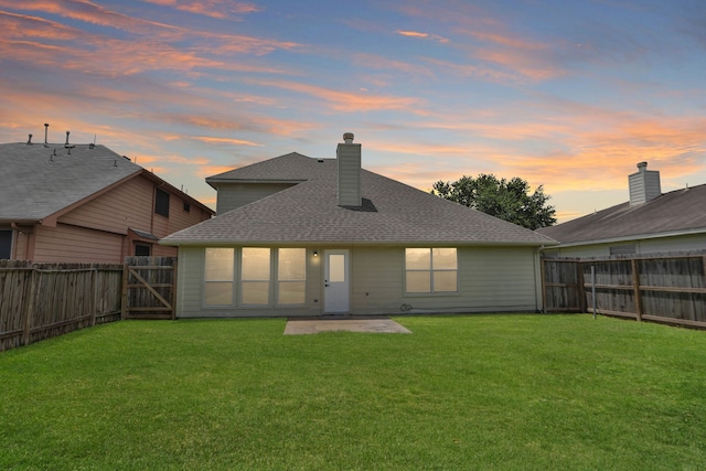 2522 Cardinal Elm St, Fresno, TX 77545 - back of property at dusk featuring a fenced backyard, a chimney, and roof with shingles