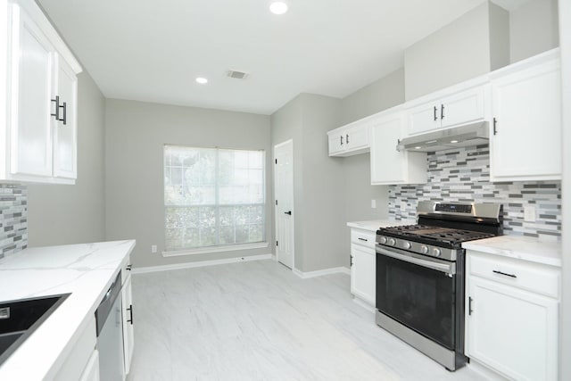 2522 Cardinal Elm St, Fresno, TX 77545 - kitchen with stainless steel appliances, under cabinet range hood, light stone counters, backsplash, and white cabinetry
