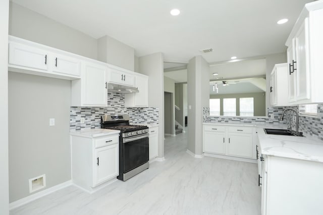 2522 Cardinal Elm St, Fresno, TX 77545 - kitchen featuring gas range, under cabinet range hood, decorative backsplash, light stone countertops, and a ceiling fan