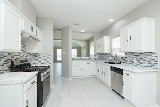2522 Cardinal Elm St, Fresno, TX 77545 - kitchen featuring appliances with stainless steel finishes, under cabinet range hood, tasteful backsplash, light stone counters, and recessed lighting
