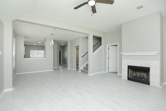 2522 Cardinal Elm St, Fresno, TX 77545 - unfurnished living room with ceiling fan, a tiled fireplace, stairs, and recessed lighting