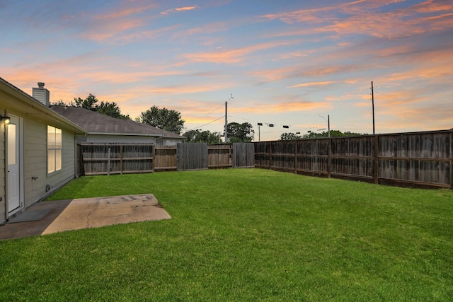 2522 Cardinal Elm St, Fresno, TX 77545 - yard at dusk with a fenced backyard and a patio