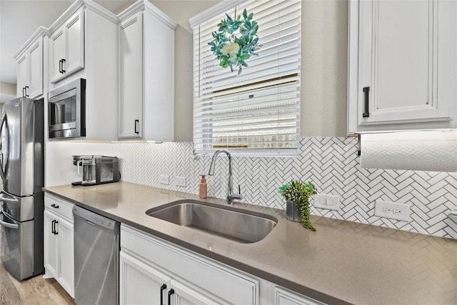 11819 Dockside Shores Dr, Cypress, TX 77433 - kitchen featuring stainless steel appliances, backsplash, white cabinets, and plenty of natural light