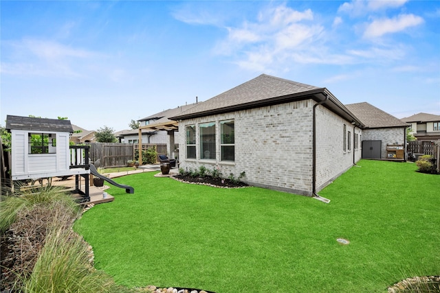 11819 Dockside Shores Dr, Cypress, TX 77433 - rear view of house with a fenced backyard, brick siding, and a shingled roof