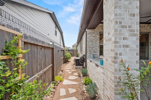 11819 Dockside Shores Dr, Cypress, TX 77433 - view of side of home featuring a central AC unit and brick siding