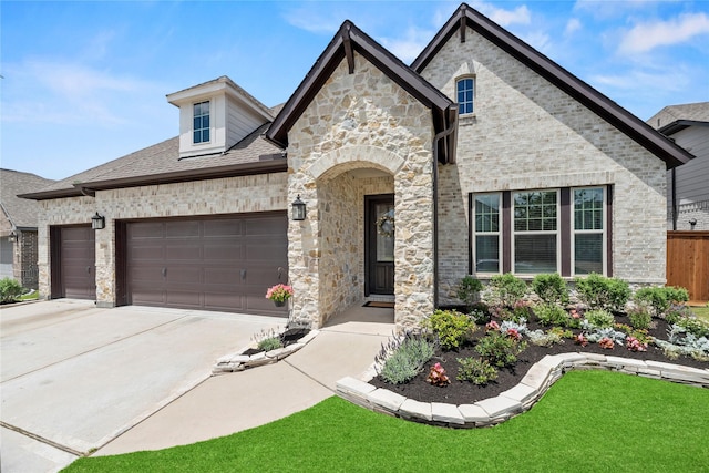 11819 Dockside Shores Dr, Cypress, TX 77433 - french country inspired facade with a garage, concrete driveway, brick siding, and stone siding