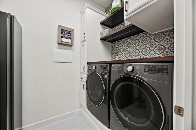 11819 Dockside Shores Dr, Cypress, TX 77433 - washroom featuring independent washer and dryer, cabinet space, and light tile patterned floors