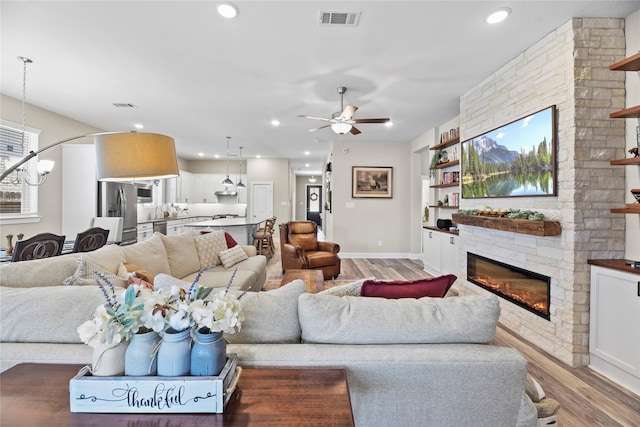 11819 Dockside Shores Dr, Cypress, TX 77433 - living room with light wood finished floors, a fireplace, a ceiling fan, and recessed lighting