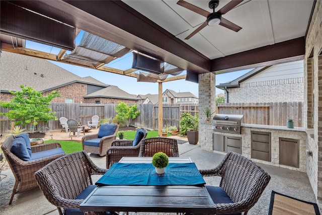 11819 Dockside Shores Dr, Cypress, TX 77433 - fenced backyard with a patio area, an outdoor kitchen, a ceiling fan, an outdoor hangout area, and outdoor dining area