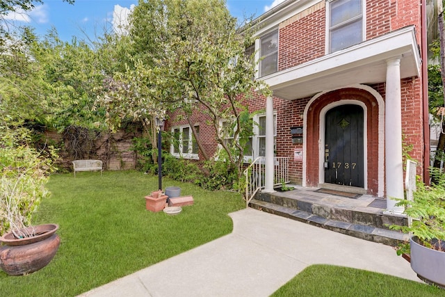 1737 Branard St, Houston, TX 77098 - doorway to property featuring brick siding and a yard