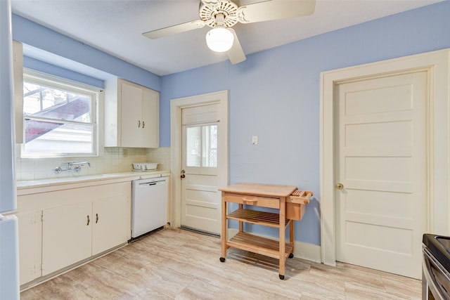 1737 Branard St, Houston, TX 77098 - kitchen featuring dishwasher, light countertops, backsplash, white cabinetry, and a ceiling fan