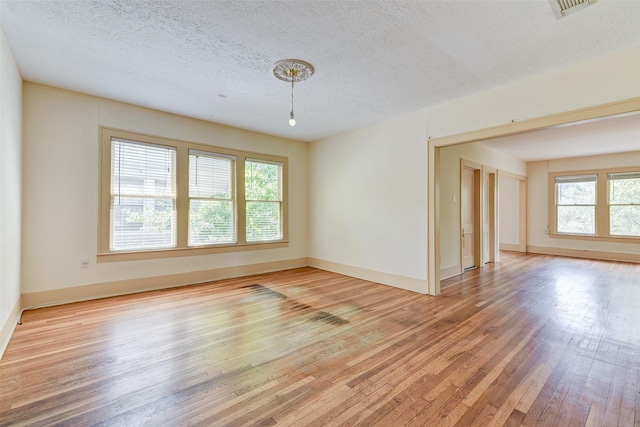 1737 Branard St, Houston, TX 77098 - unfurnished room with light wood finished floors and a textured ceiling