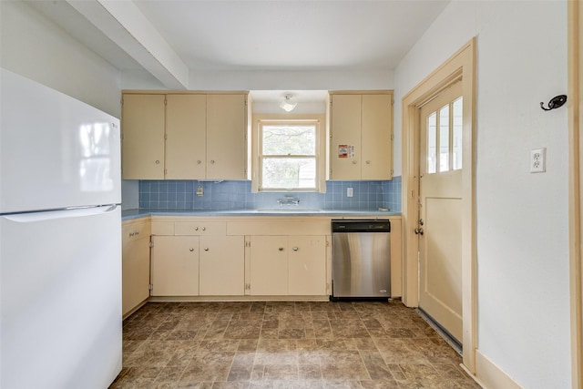1737 Branard St, Houston, TX 77098 - kitchen featuring freestanding refrigerator, stainless steel dishwasher, cream cabinets, and decorative backsplash