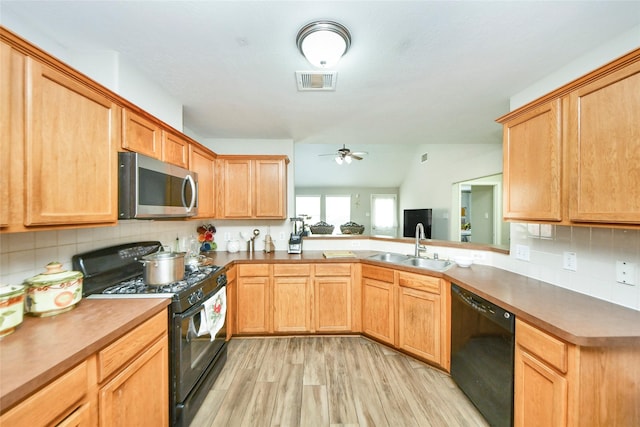 14503 Brackenhurst Ln, Houston, TX 77049 - kitchen featuring black appliances, light wood finished floors, tasteful backsplash, and ceiling fan